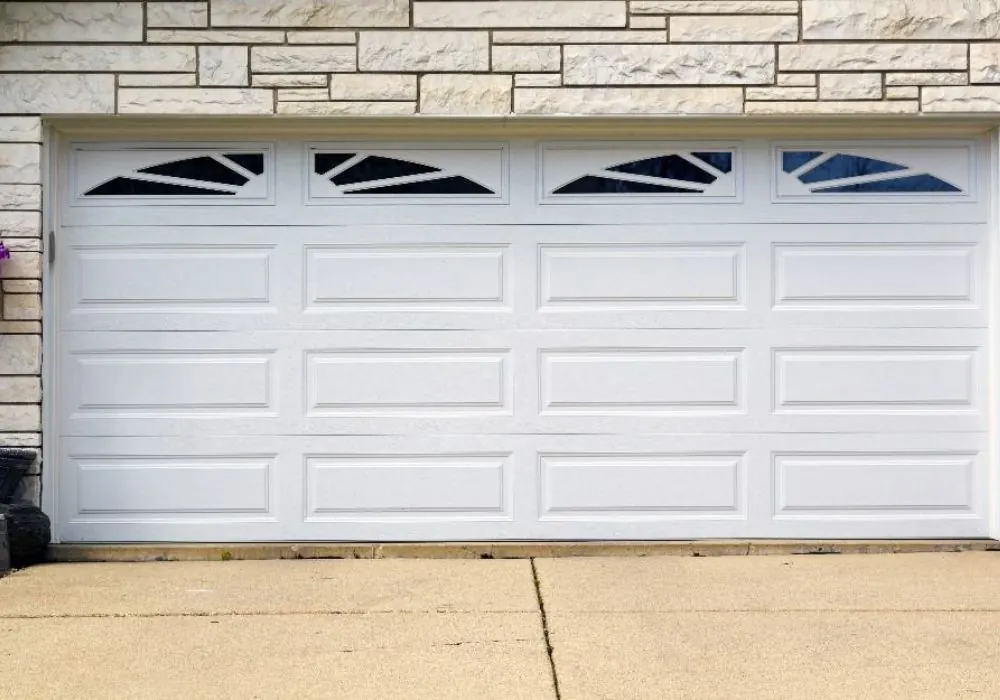Double-width white garage door with arched windows