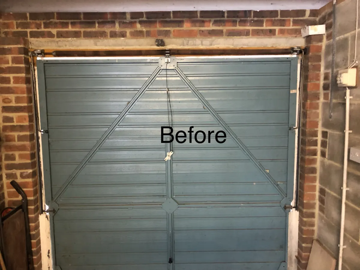Up and over garage door mechanism before servicing