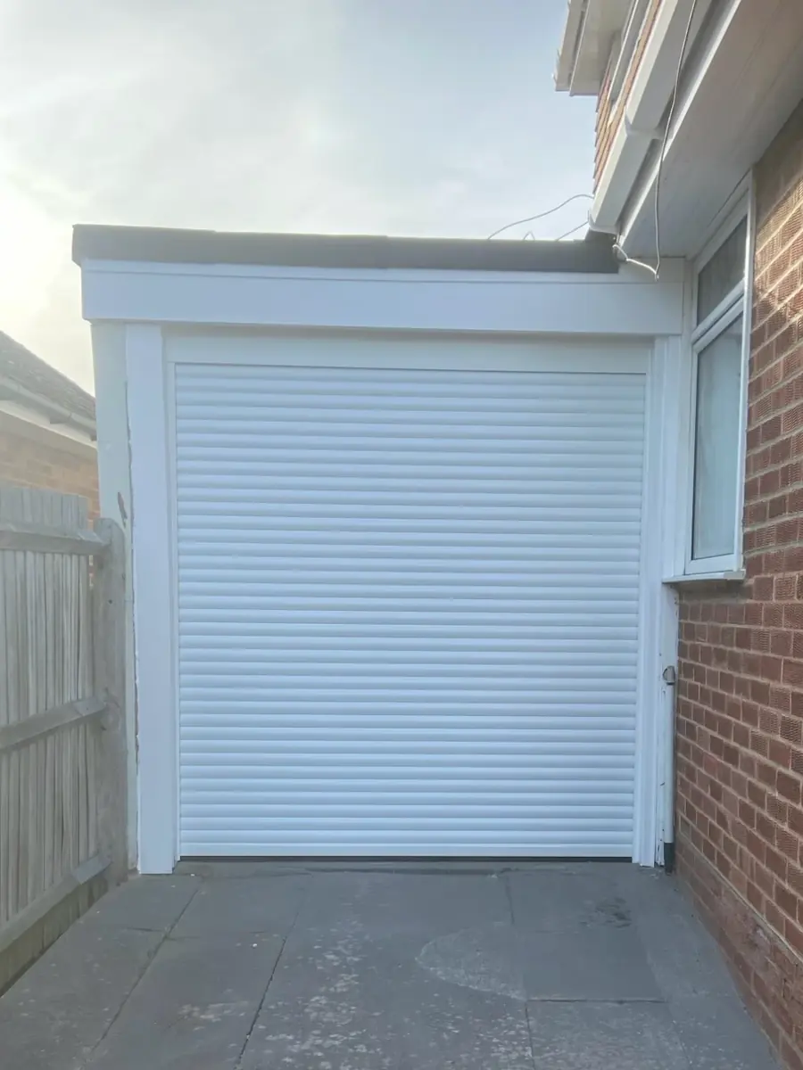 The same garage with a new white roller door