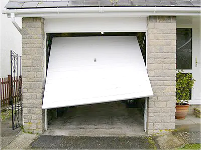 Up and over garage door jammed partly open